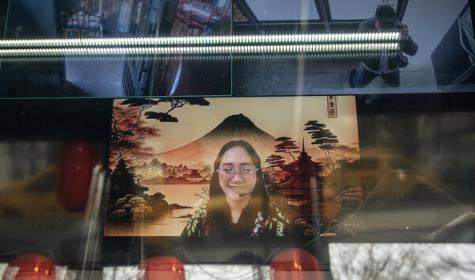 A remote cashier appears on a screen at an outlet of the SanSan Ramen restaurant, in New York, April 4, 2024. A handful of New York City restaurants are experimenting with virtual staff members, who greet customers on a screen via Zoom from the Philippines. 