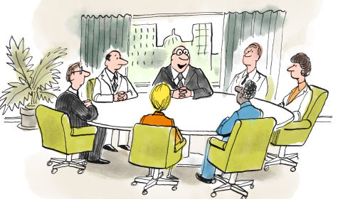 several members of a business team sitting down for a meeting