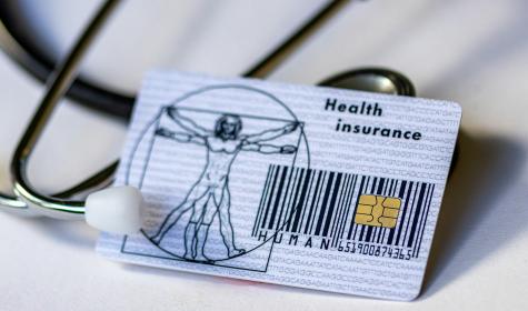 A health insurance card and stethoscope