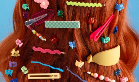 red hair filled with a diverse assortment of hair slides and clips