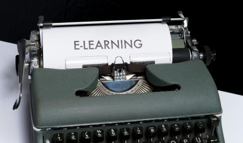 a sheet of paper that says "e-learning" on it coming out of a typewriter