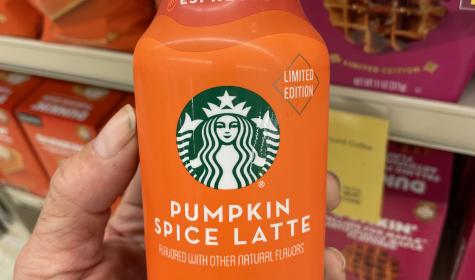 Someone holding a bottle of Starbucks Pumpkin Spice Latte iced espresso