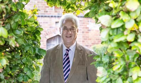 Adrian Fisher standing in a garden