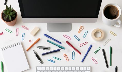 A shot of a messy desk from above