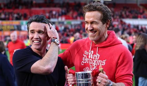Ryan Reynolds and Rob McElhenney co owners of Wrexham with the trophy during the Sky Bet League One match between Wrexham AFC and Charlton Athletic FC at Racecourse Ground on April 26, 2025 in Wrexham, Wales.